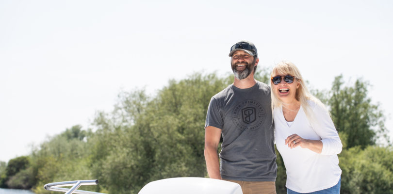 Man and a woman on a Norfolk Broads hire boat